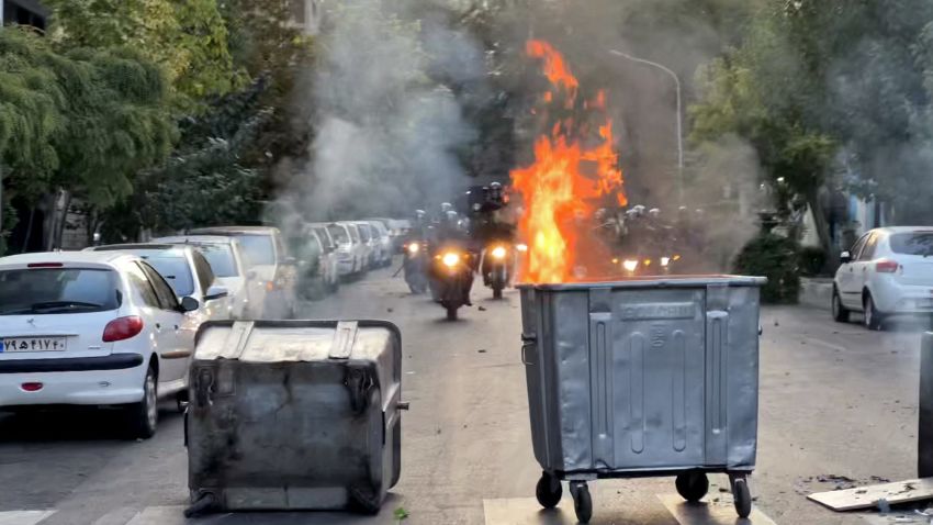 A picture obtained by AFP outside Iran shows a bin burning in the middle of an intersection during a protest for Mahsa Amini, a woman who died after being arrested by the Islamic republic's "morality police", in Tehran on September 20, 2022. - Public anger has grown in Iran since authorities on September 16 announced the death of 22-year-old Mahsa Amini, after her arrest by the police unit responsible for enforcing a strict dress code for women. (Photo by AFP) (Photo by -/AFP via Getty Images)