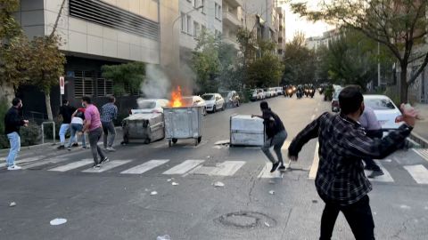 A trash can burns in the middle of an intersection during protests in Tehran, Iran, on Sept. 20.