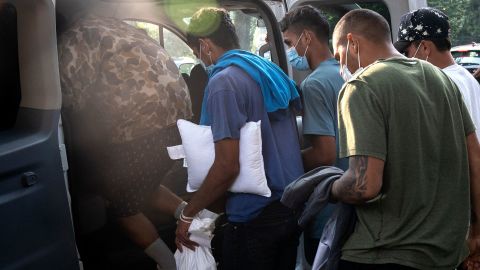 Migrants from Venezuela, who boarded a bus in Texas, wait to be taken to a local church by volunteers after being dropped off outside the residence of US Vice President Kamala Harris on September 15.