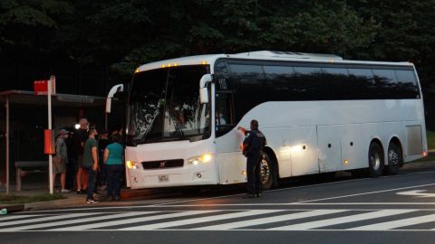 A group of mainly Venezuelan migrants, who were sent by bus from detention in Texas, are dropped off outside the Naval Observatory, the official residence of U.S. Vice President Kamala Harris in Washington, DC, on September 17.