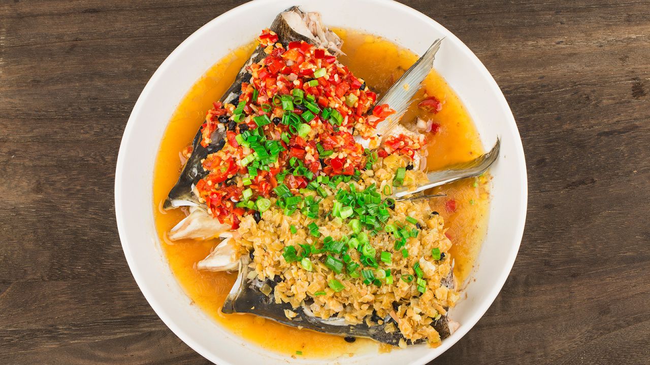 <strong>Steamed fish head with chopped salted chili: </strong>No other dish represents Hunan cuisine as well as steamed fish heads served with chopped salted chili (<em>duo jiao yu tou</em>). <em>Duo jiao</em>, a staple relish in Hunanese homes, is made with chili peppers that are dried, diced then preserved in a jar of salt, ginger, garlic and <em>baijiu </em>(Chinese liquor) for at least a week. 
