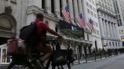 A man bikes past the New York Stock Exchange, Wednesday, Sept. 21, 2022, in New York. Stocks are off to a modestly higher start on Wall Street ahead of a widely expected interest rate increase by the Federal Reserve. The S&P 500 was up half a percent in the early going Wednesday, as was the Dow Jones Industrial Average.  (AP Photo/Peter Morgan)