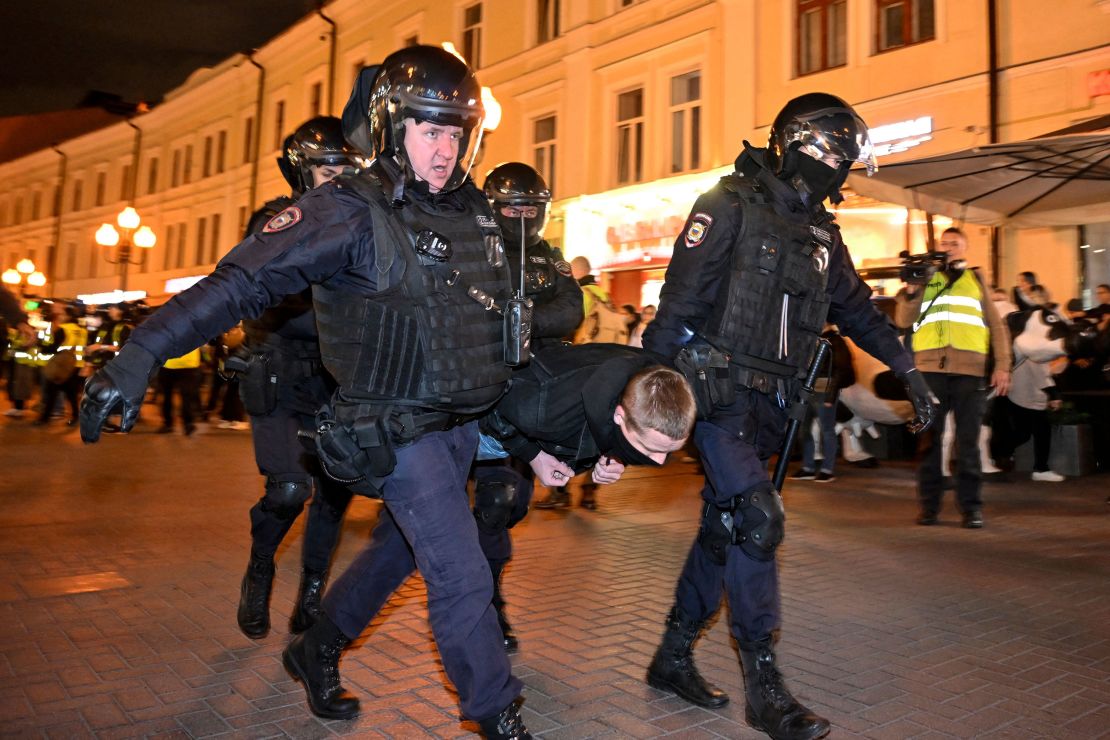 Police officers detain a man in Moscow amid protests against Putin's mobilization of citizens.