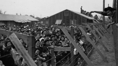 Japanese-American internees wave to friends departing by train from the Santa Anita Assembly Center in Arcadia, California in 1942.