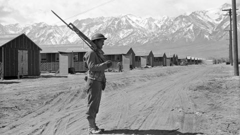A US soldier stands guard at a concentration camp at Manzanar, California, on May 23, 1943.