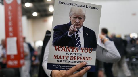 An attendee holds a sign in support of Matthew DePerno, the Republican nominee for Michigan attorney general, at a GOP convention in Grand Rapids, Michigan, on April 23, 2022.  