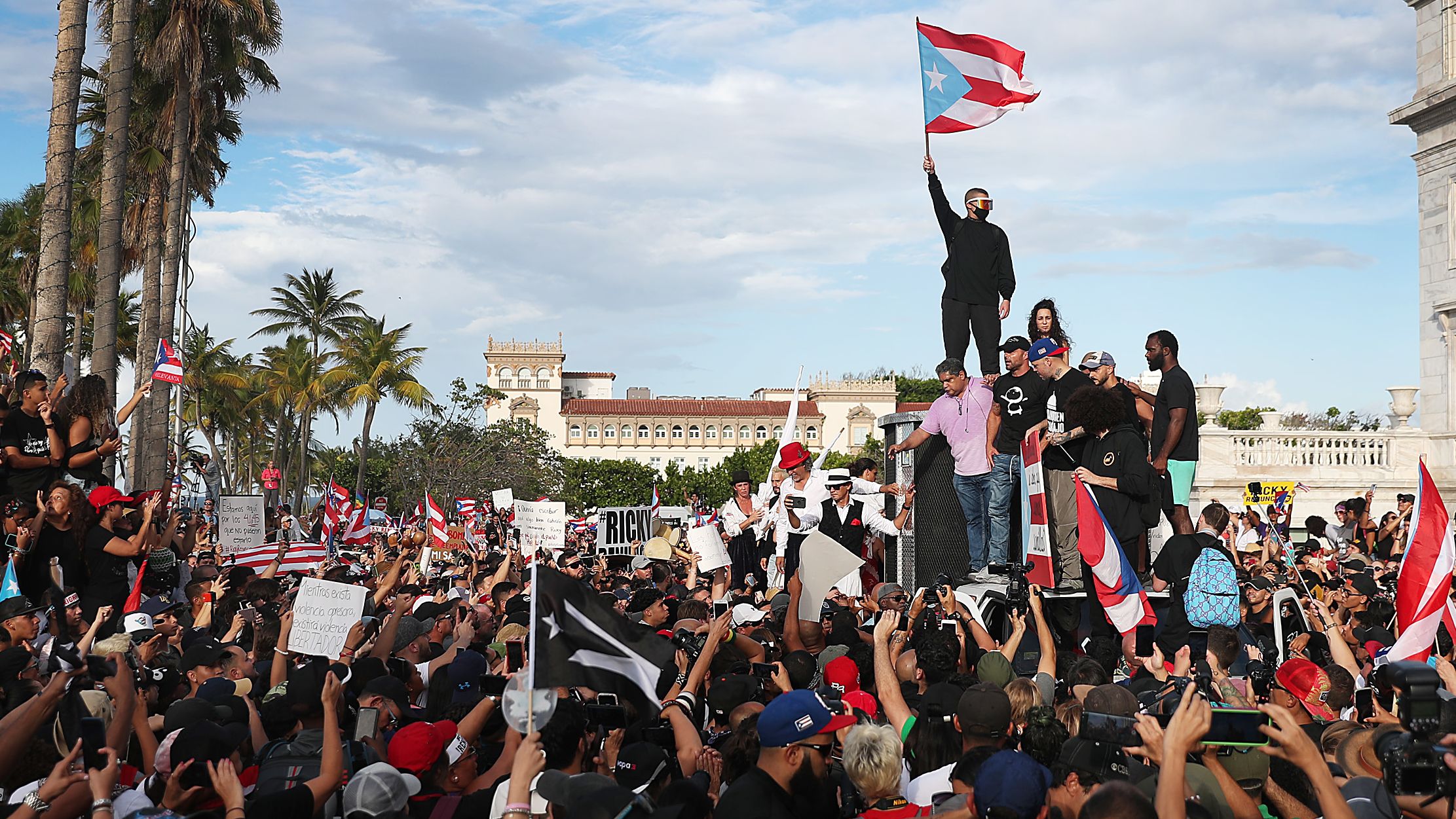 Bad Bunny (holding flag), Ricky Martin (black hat) and Residente (blue hat) join demonstrators protesting against Ricardo Rosselló, the then-governor of Puerto Rico, who was ousted after massive protests in Puerto Rico in 2019.