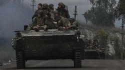 TOPSHOT - Ukrainian soldiers sit on infantry fighting vehicles as they drive near Izyum, eastern Ukraine on September 16, 2022, amid the Russian invasion of Ukraine. (Photo by Juan BARRETO / AFP) (Photo by JUAN BARRETO/AFP via Getty Images)