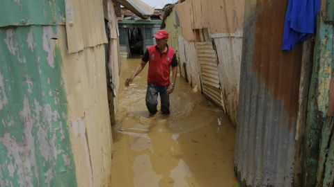 Ruinous Hurricane Fiona Reaches Category 4 As It Moves North, Leaving Disaster-Stricken Areas On Slow Road To Recovery | CNN 3 Nicasio Gil walks through the stagnant water left by the swollen Duey River while grappling with the aftermath of Hurricane Fiona in Higuey, Dominican Republic, on Tuesday, September 20.
