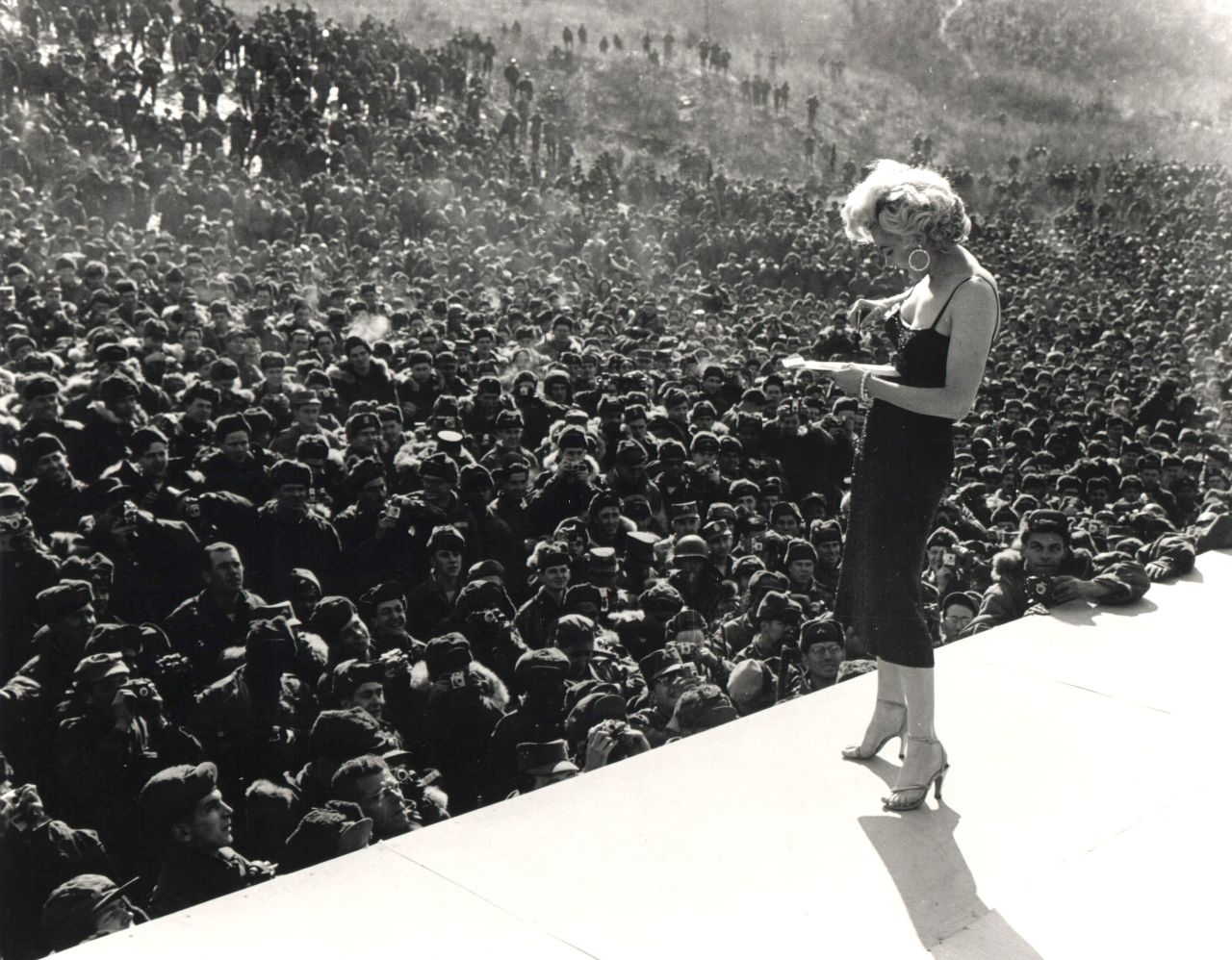 Monroe signs an autograph for a US serviceman in Korea as part of the USO program.