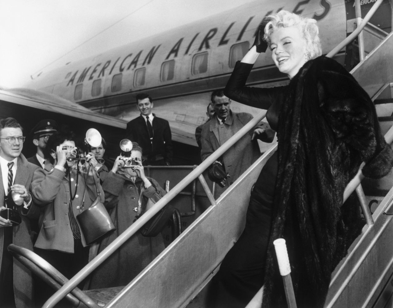 Marilyn Monroe poses at Idlewild as she boards an American Airlines plane for Hollywood in 1956.