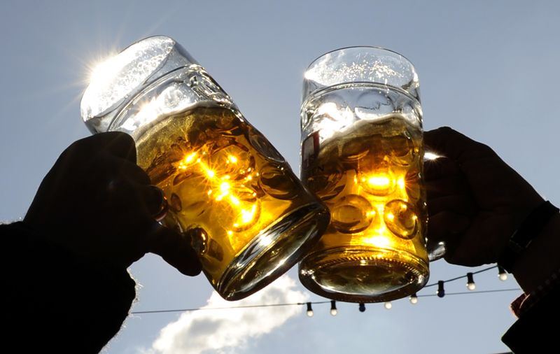 Visitors toast each other on a sunny day during Oktoberfest in Munich.