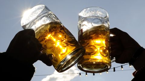 Visitors toast each other during Oktoberfest in Munich, Germany.