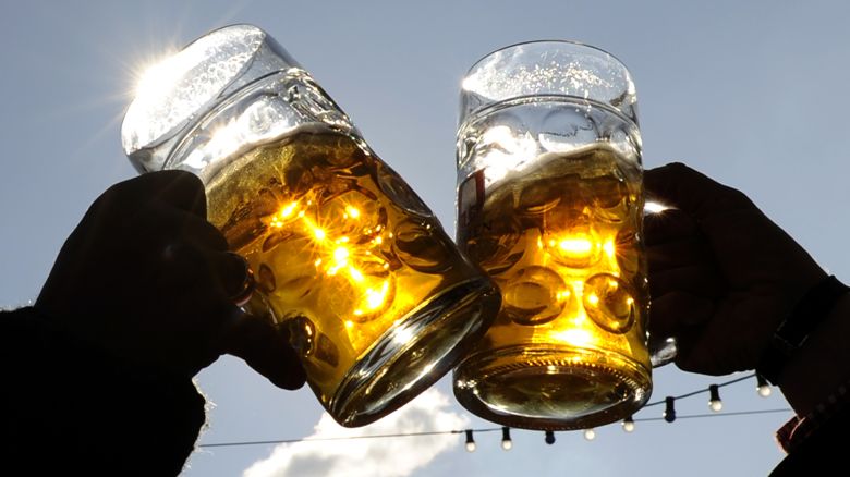 Visitors toast each other on a sunny day during Oktoberfest in Munich.