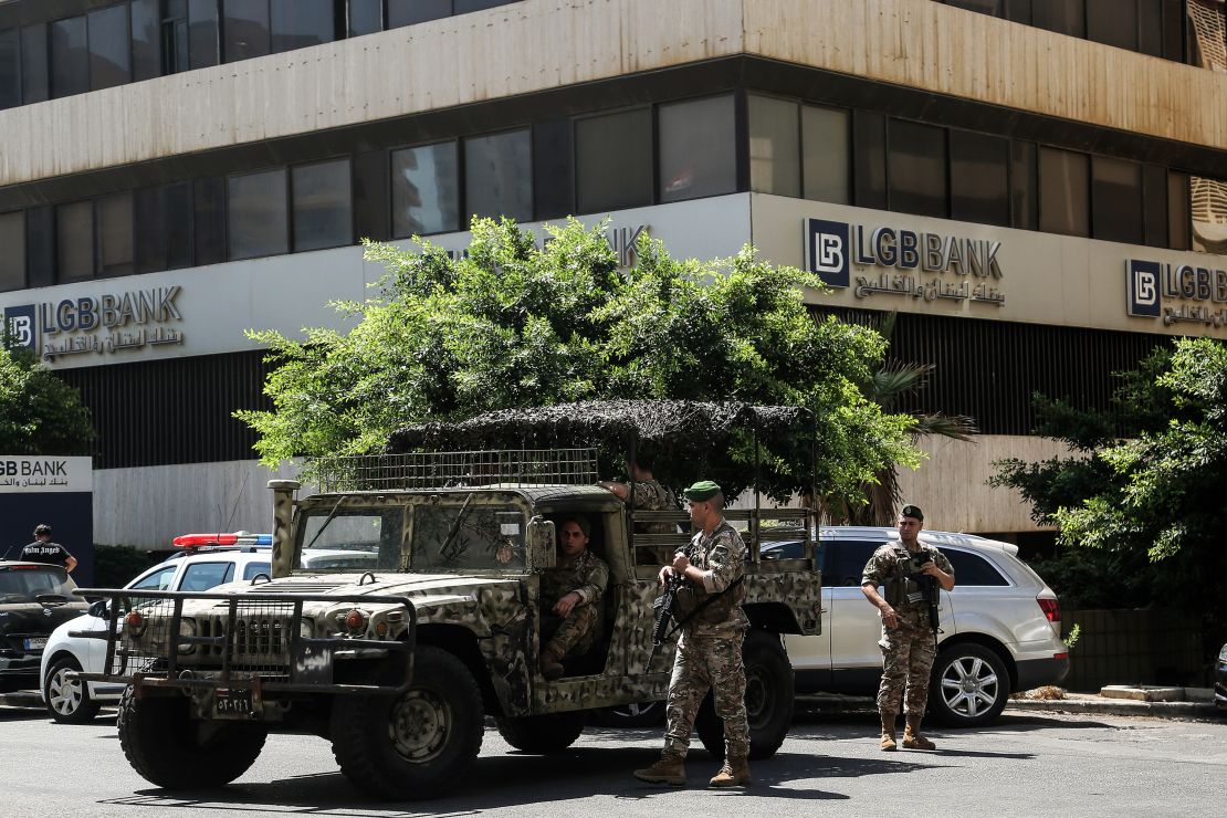 Lebanese army soldiers secure the premises near a bank in Beirut after a depositor stormed the branch demanding access to his money.