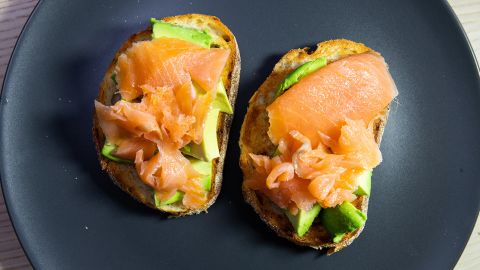 Top slices of toasted sourdough bread with smoked salmon and avocado.