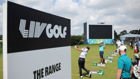 Players practice on the driving range ahead of the LIV golf event in St Albans, England in June. 