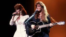 Country music duo the Judds, with Naomi Judd (left) and her daughter Wynonna, perform onstage, Chicago, Illinois, February 1, 1991. (Photo by Paul Natkin/Getty Images)