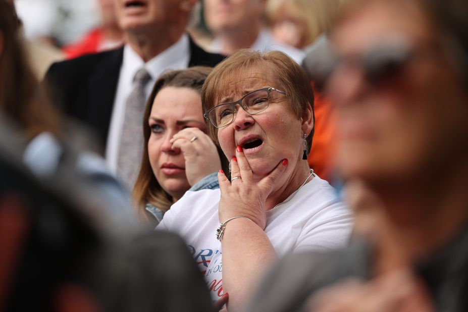 Mourners outside Windsor Castle react while watching coverage of Queen Elizabeth II's funeral on Monday, September 19.