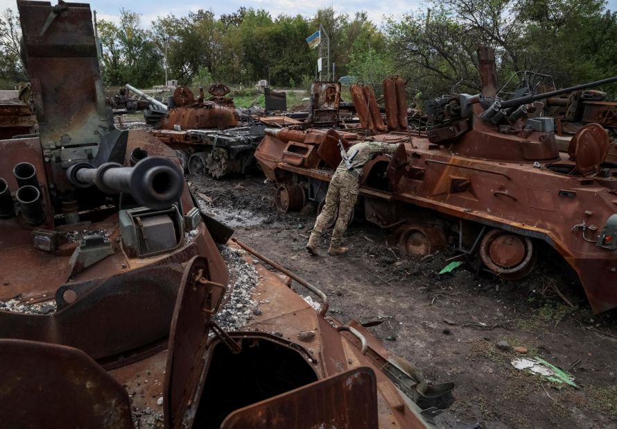 A Ukrainian serviceman checks a destroyed Russian military vehicle in the Ukrainian town of Izium on Tuesday, September 20. <a href="https://www.cnn.com/2022/09/13/europe/ukraine-izium-recaptured-intl-cmd/index.html" target="_blank">Izium has now been "liberated"</a> along with almost the whole of Kharkiv region, a Ukrainian military source told CNN. The city is a huge strategic loss for the Russian military, which used it as a key base and resupply route for its forces in eastern Ukraine.