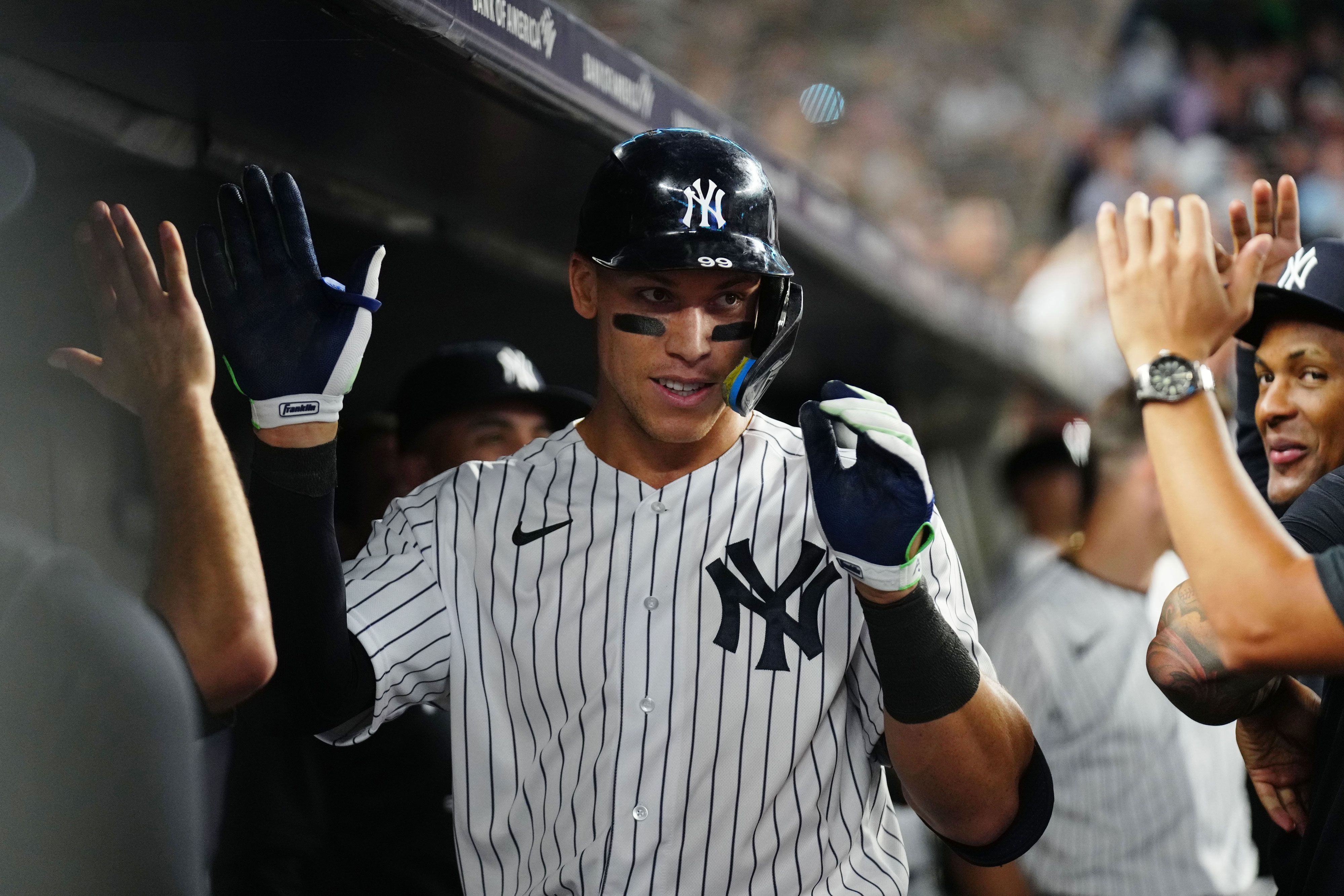 New York Yankees slugger Aaron Judge is congratulated in the dugout after hitting his 60th home run of the Major League Baseball season on Tuesday, September 20.