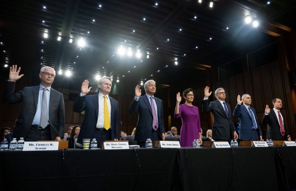 CEOs of the nation's largest banks are sworn in to testify before a US Senate committee as part of an oversight hearing in Washington, DC, on Thursday, September 22. From left are Charles Scharf, CEO and president of Wells Fargo; Brian Thomas Moynihan, chairman and CEO of Bank of America; Jamie Dimon, chairman and CEO of JPMorgan Chase; Jane Fraser, CEO of Citigroup; William H. Rogers Jr., chairman and CEO of Truist Financial Corp.; Andy Cecere, chairman, president and CEO of US Bancorp; and William Demchak, chairman, president and CEO of The PNC Financial Services Group.