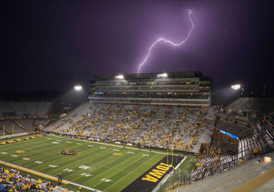 A lightning bolt flashes near Kinnick Stadium in Iowa City, Iowa, on Saturday, September 17. There were several lightning delays in the college football game between Iowa and Nevada. The game didn't end until 1:39 a.m. local time.