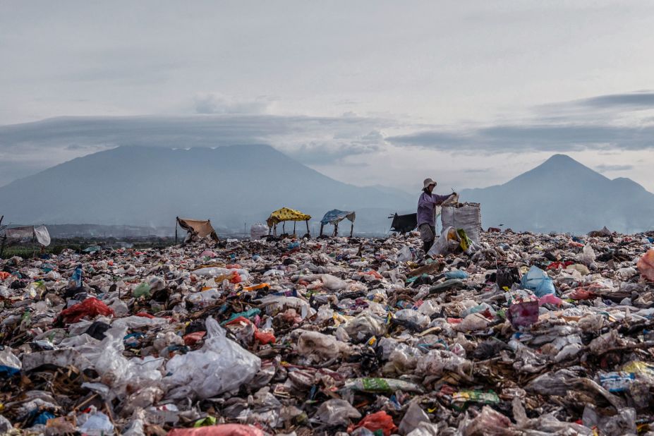 A ragpicker collects recyclable materials at a landfill in Sidoarjo, Indonesia, on Friday, September 16. 