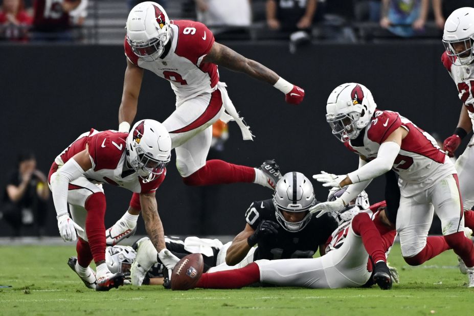 Arizona cornerback Byron Murphy Jr., left, picks up a fumble in overtime and returns it for the game-winning touchdown during an NFL game in Las Vegas on Sunday, September 18.