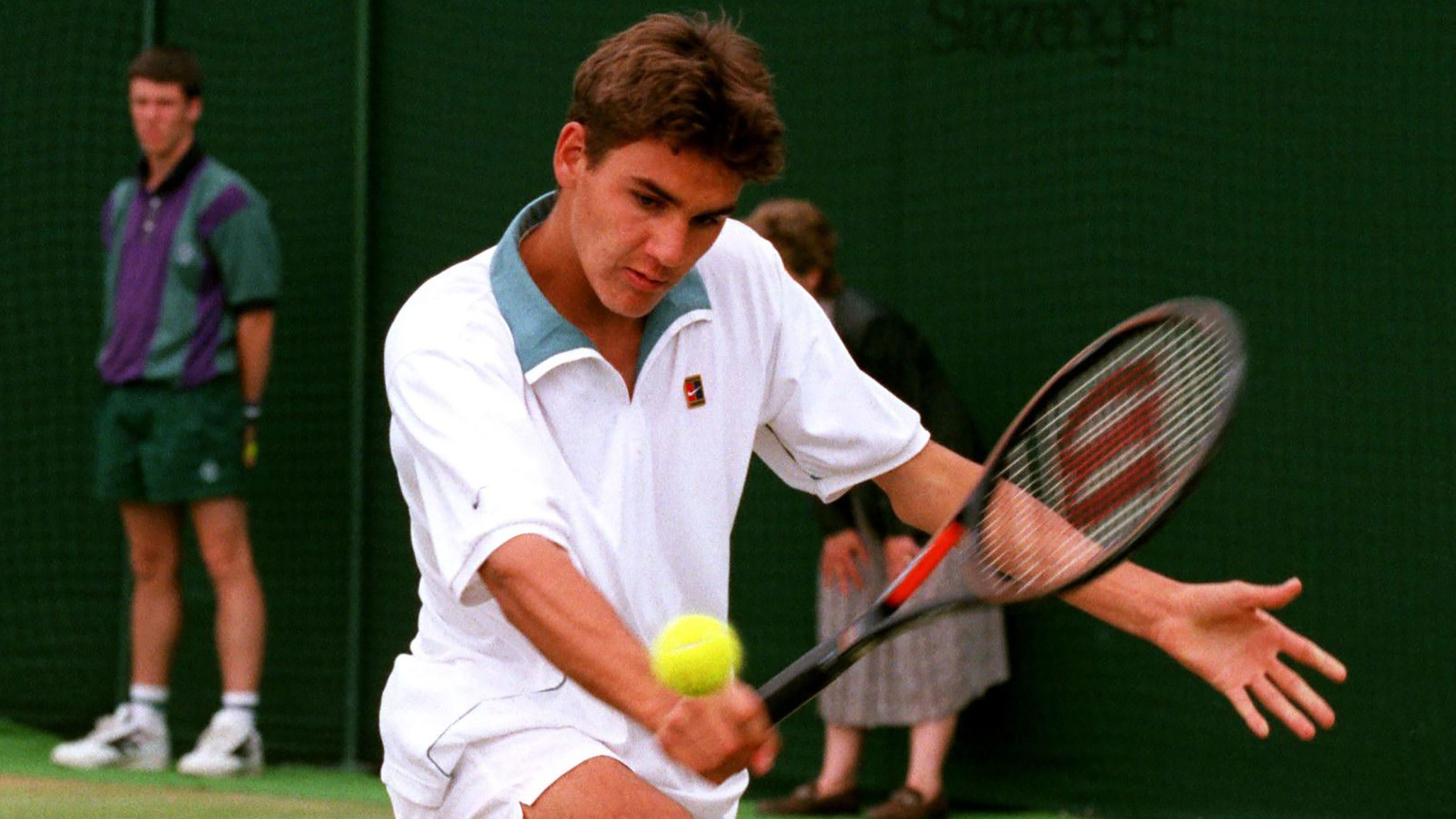 A teenage Federer hits a shot while on his way to winning the junior title at Wimbledon in 1998.