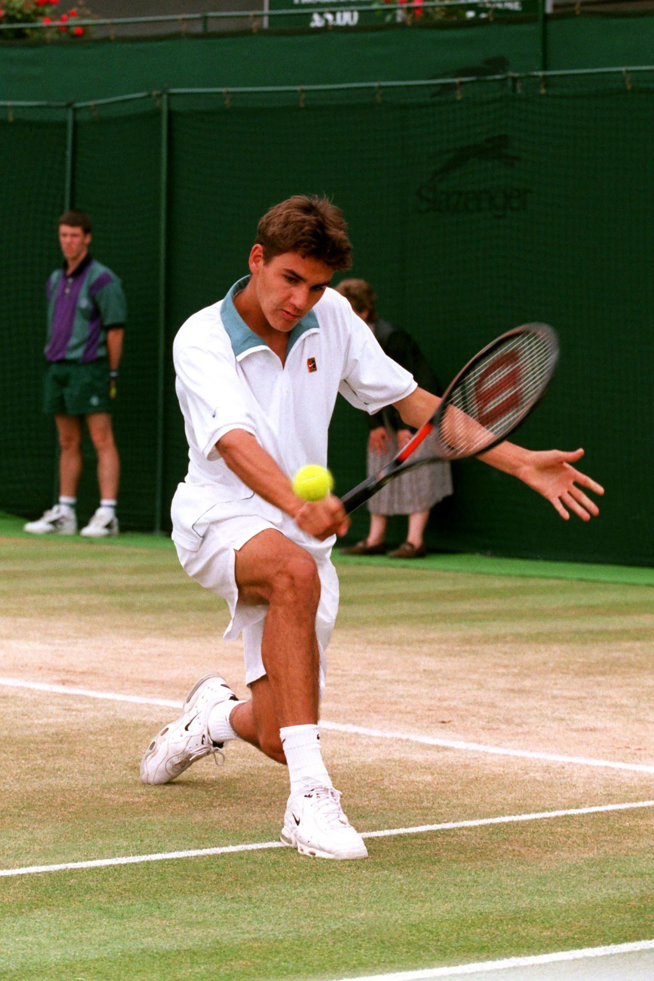 A teenage Federer hits a shot while on his way to winning the junior title at Wimbledon in 1998.