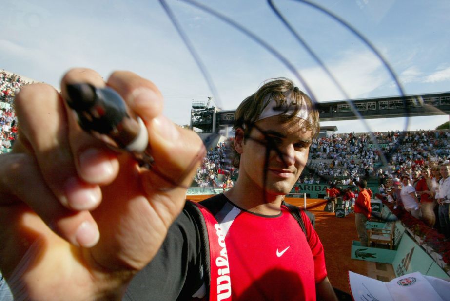 Federer signs a camera after a French Open match in 2005.