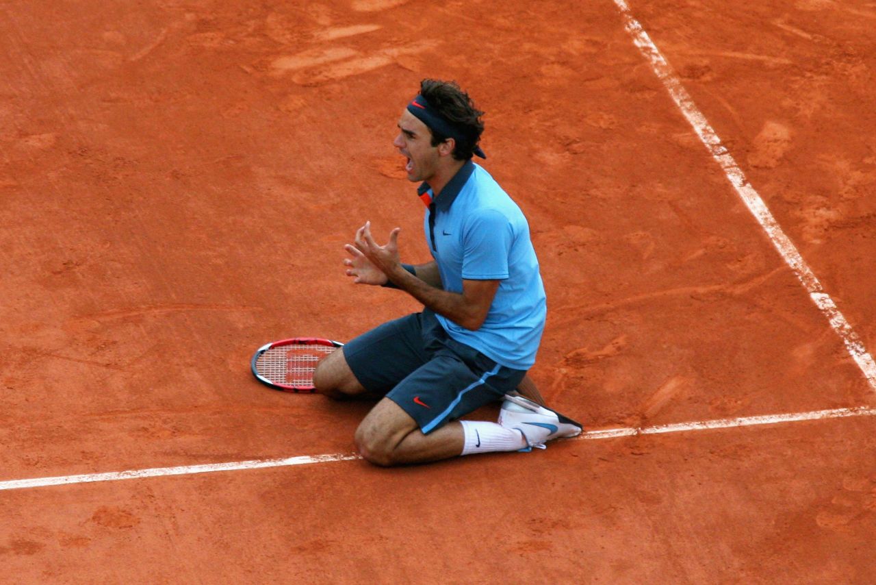 Federer falls to his knees after winning the French Open in 2009. The elusive title completed the career grand slam for Federer.
