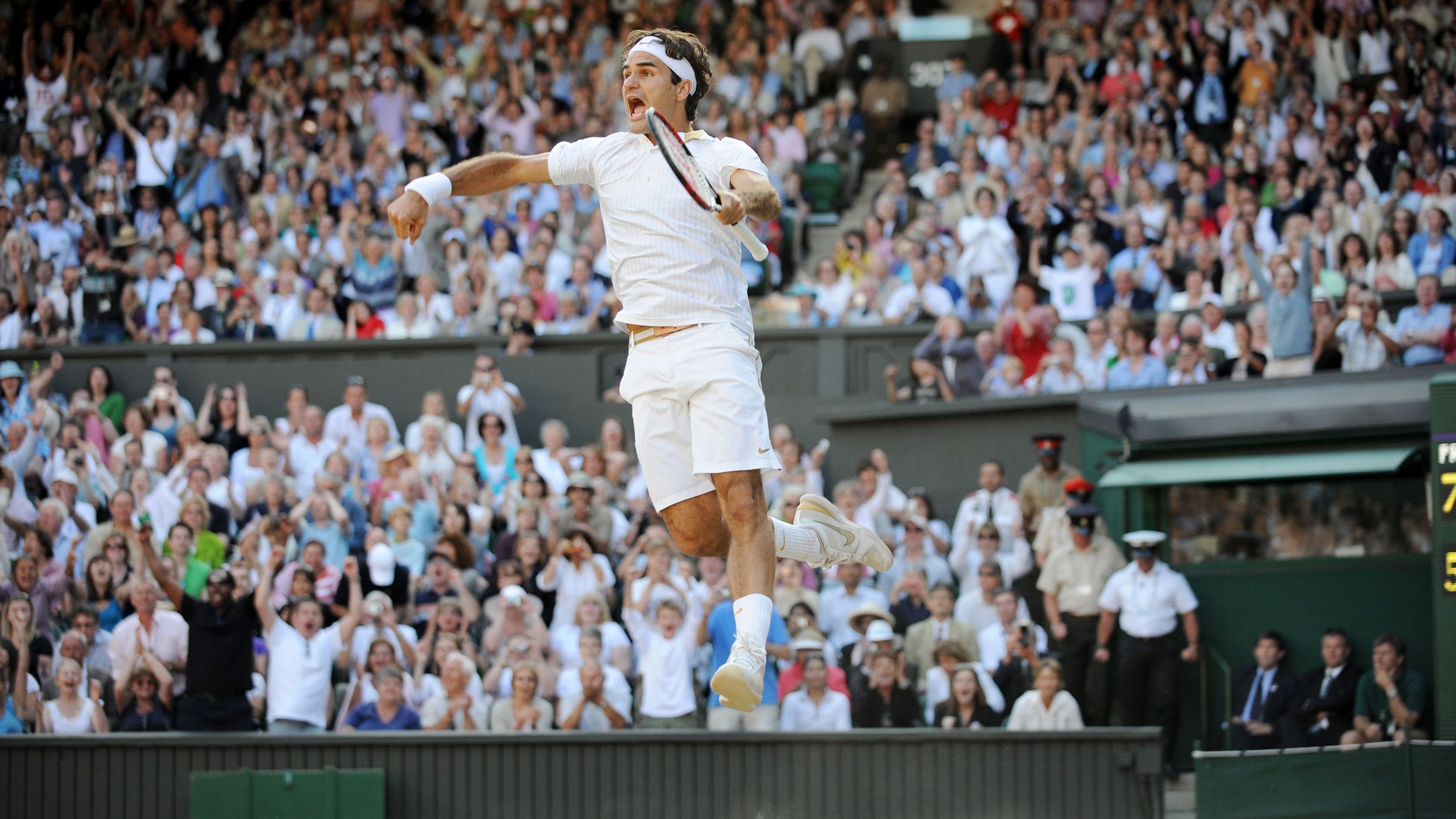 Federer celebrates after winning Wimbledon in 2009. It was his 15th major title, which at the time was the most ever for a men's tennis player.