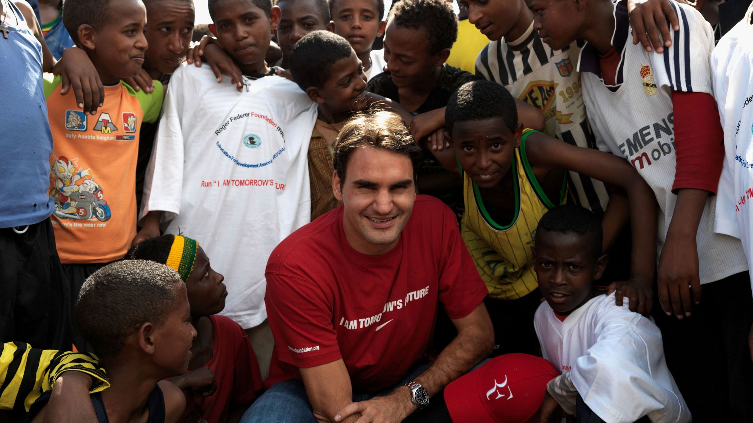 Federer poses with children in Kore Roba, Ethiopia, while visiting a school funded by his charity, the Roger Federer Foundation, in 2010.