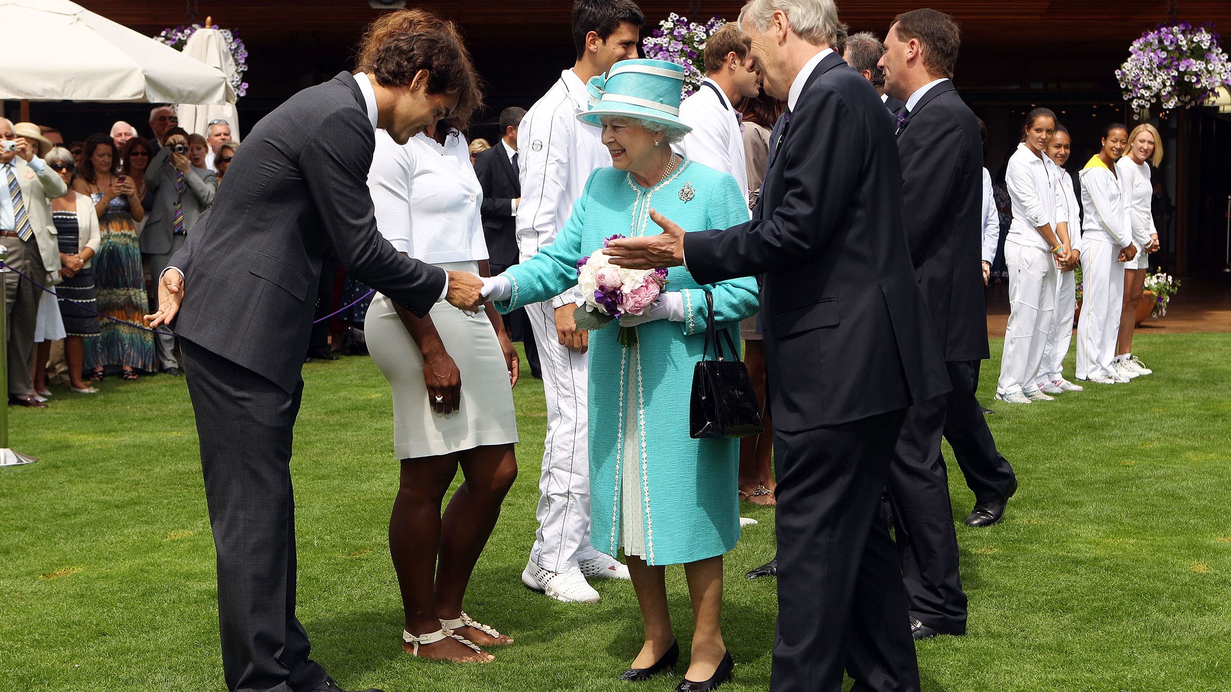 Federer greets Britain's Queen Elizabeth II while she attended Wimbledon in 2010.