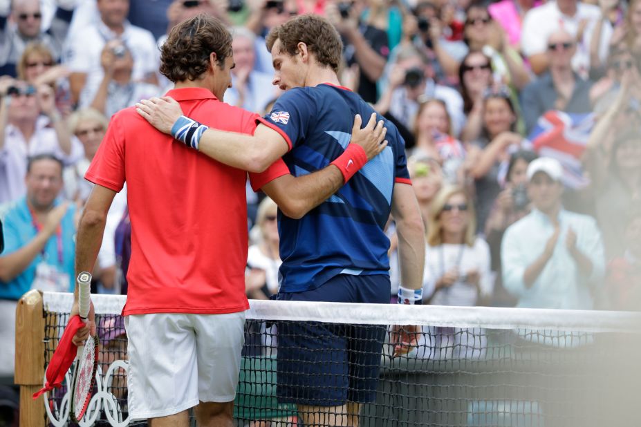 Federer walks off the court with Murray after Murray defeated him in the final of the 2012 Olympics in London.