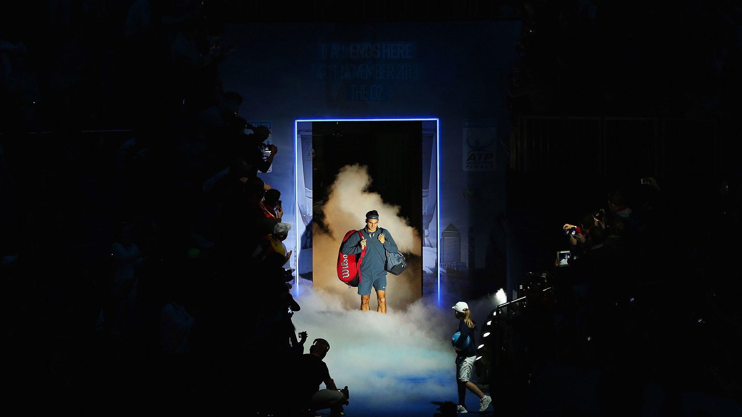 Federer walks onto the court for a match at the ATP World Tour Finals in 2013.