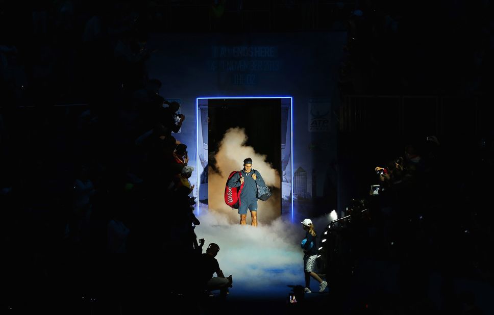 Federer walks onto the court for a match at the ATP World Tour Finals in 2013.