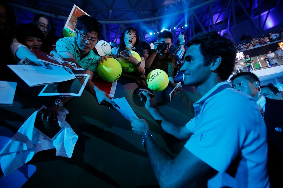 Federer signs autographs for fans in Shanghai, China, in 2013.