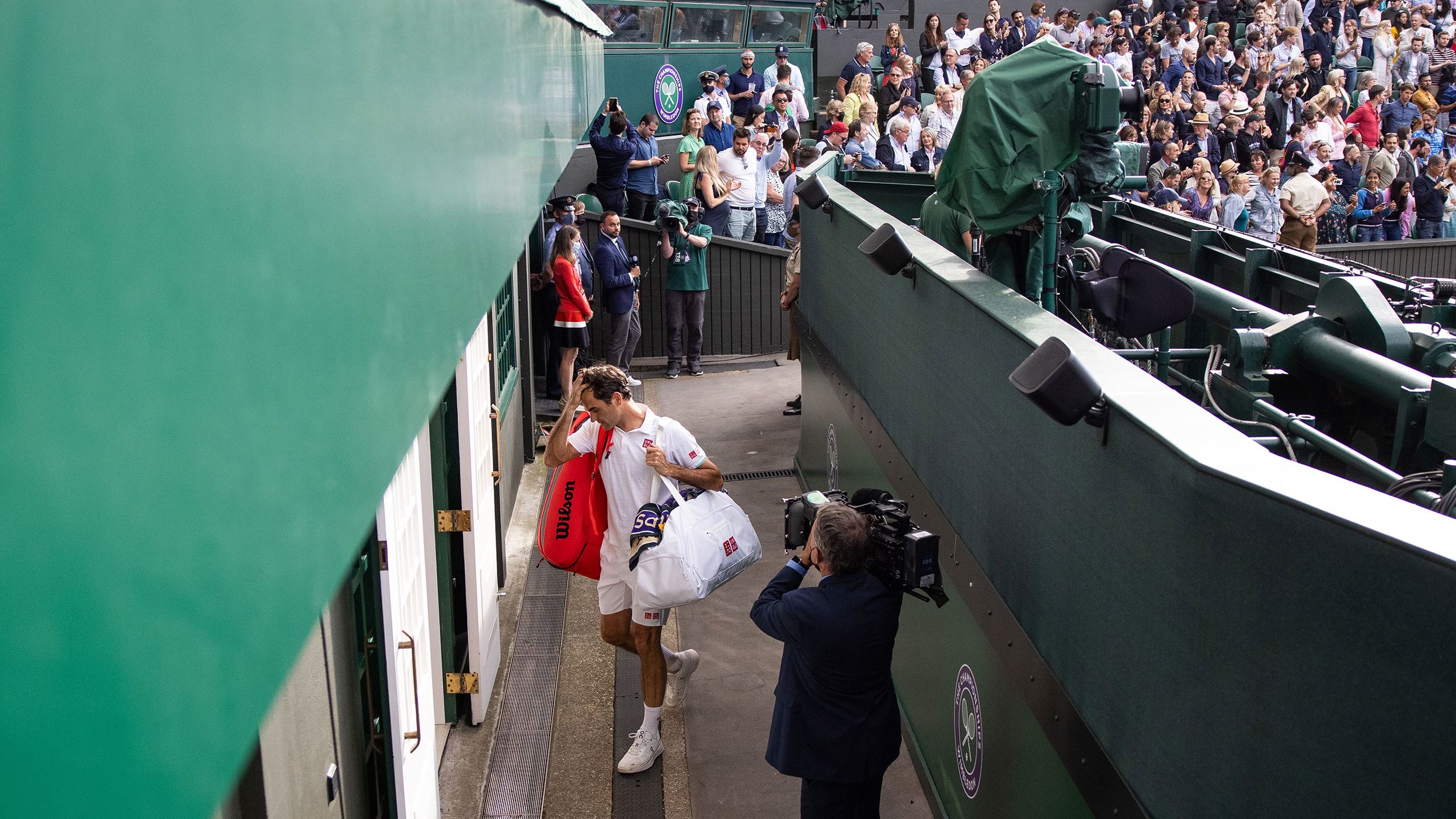 Federer leaves Centre Court at Wimbledon after losing in the quarterfinals in 2021.