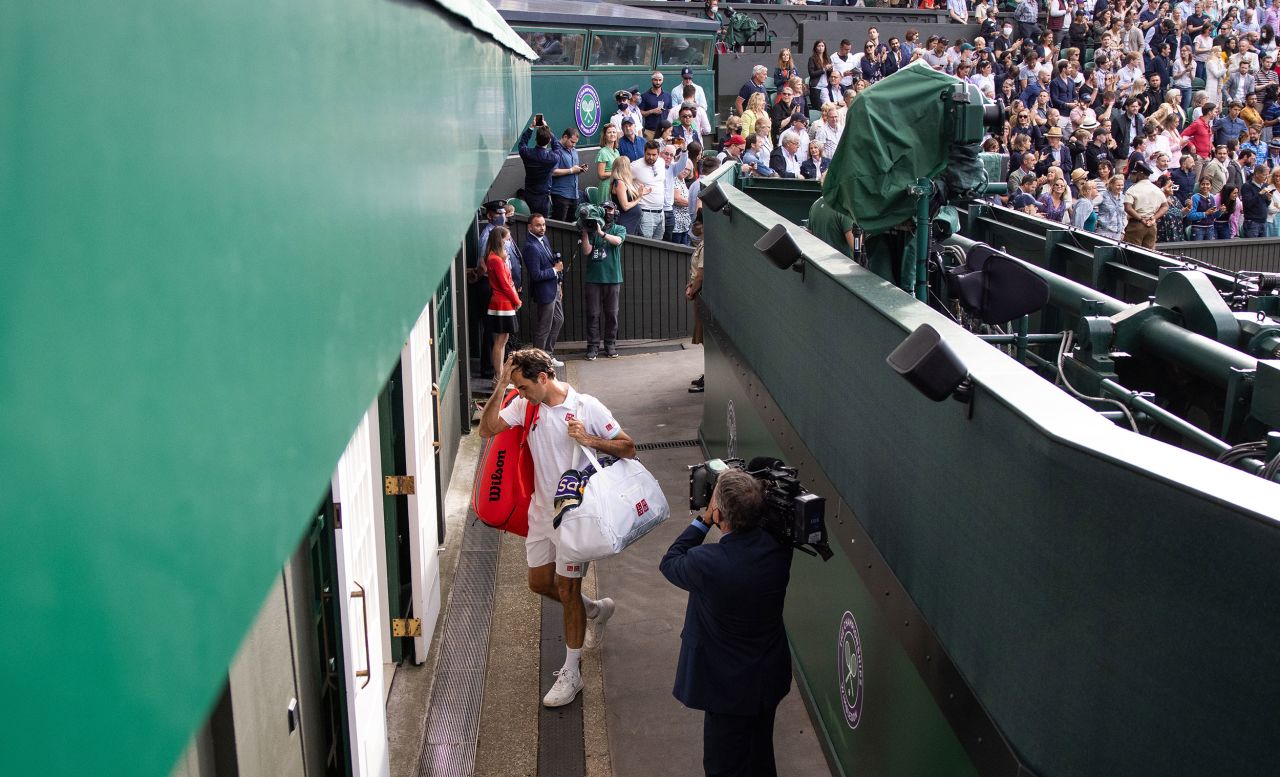 Federer leaves Centre Court at Wimbledon after losing in the quarterfinals in 2021.