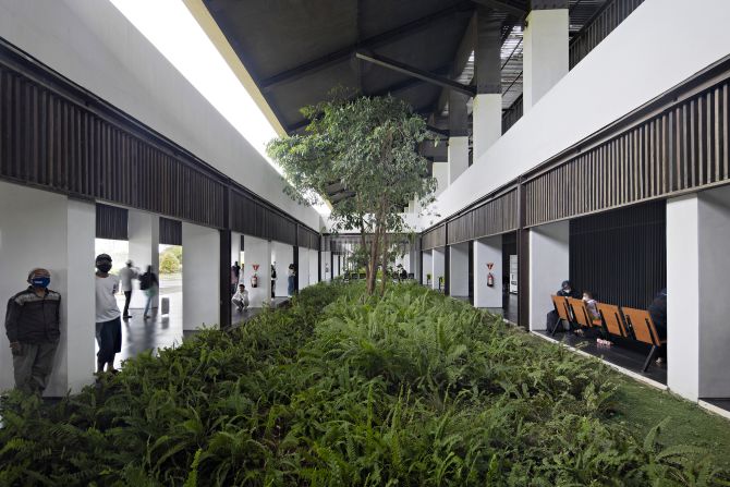 Inside, the grass-covered terminal building features lush plant life.