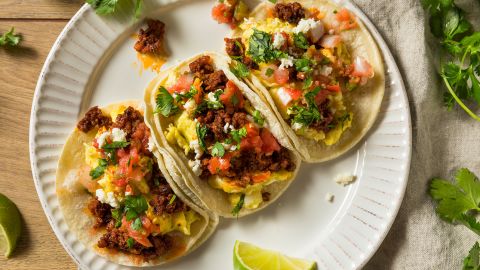 Set an alarrm for breakfast tacos like these, with chorizo, scrambled egg, diced tomatoes and cilantro.