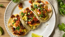 Set an alarrm for breakfast tacos like these, with chorizo, scrambled egg, diced tomatoes and cilantro.