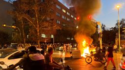 A police motorcycle burns during a protest on September 19 over the death of Mahsa Amini, a woman who died after being arrested by the Iran's "morality police" in Tehran.