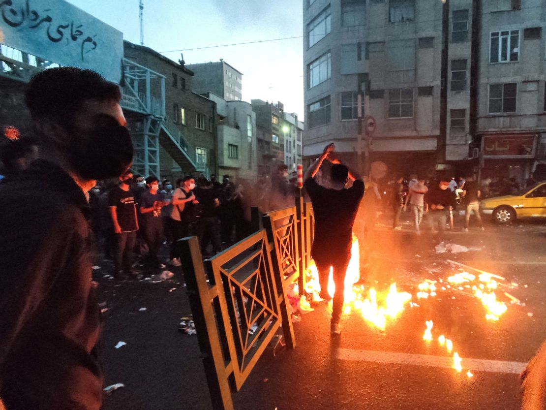 People light a fire during a protest over the death of Mahsa Amini in Tehran on September 21, 2022.