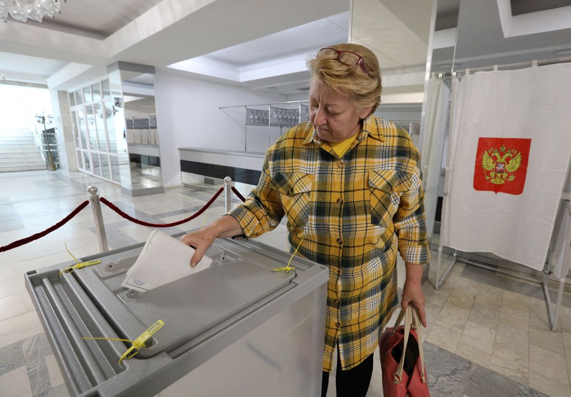 A woman casts her ballot in Sevastopol, Crimea, on  September 23, 2022.