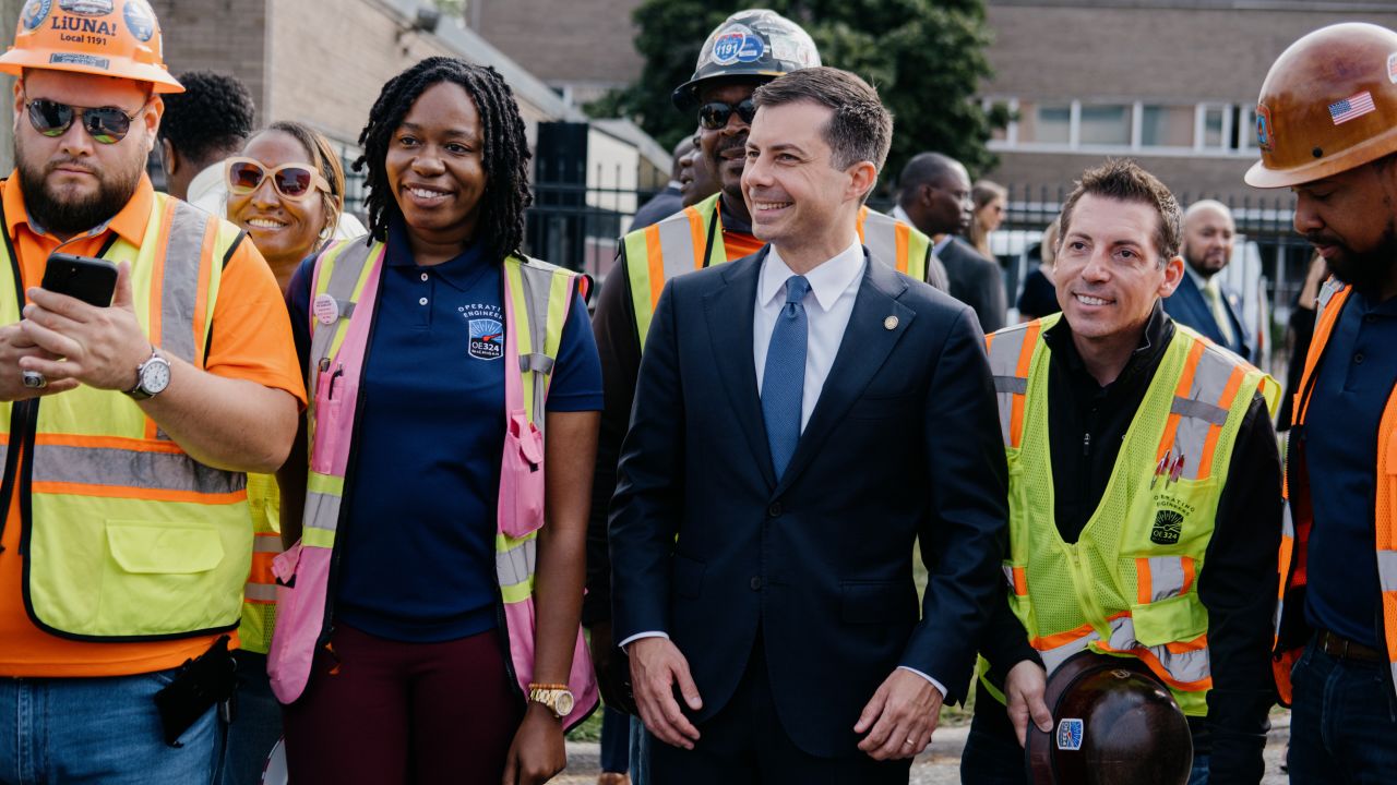 Transportation Secretary Pete Buttigieg, center, is seen during a press conference in Detroit earlier this month, touting infrastructure projects.