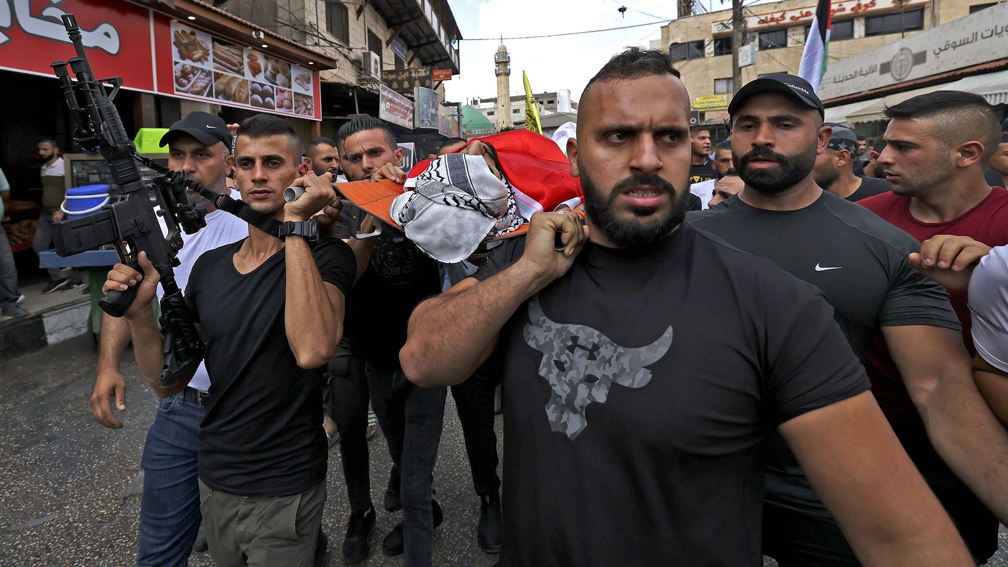 Mourners march the body of 29-year-old Palestinian Mohammed Sabaaneh during his funeral in Jenin in the occupied West Bank on September 6. 